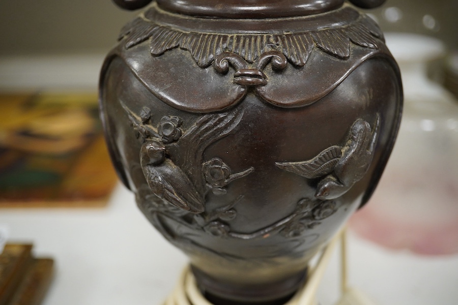 A Japanese bronze vase, converted to a lamp on carved wooden stand, 34.5cm high not including fitting. Condition - drilled to base